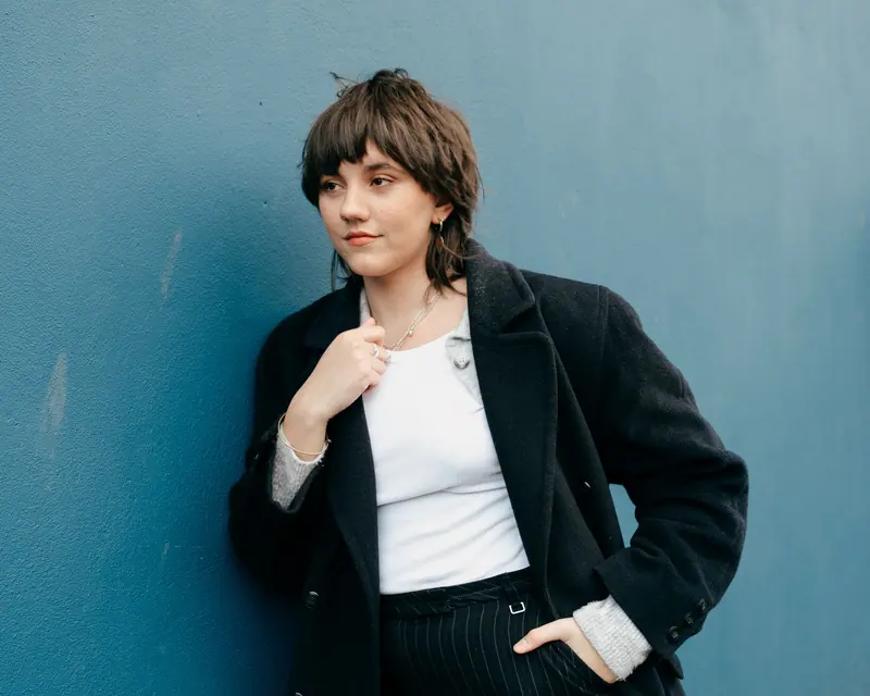 Shag and a navy coat against blue