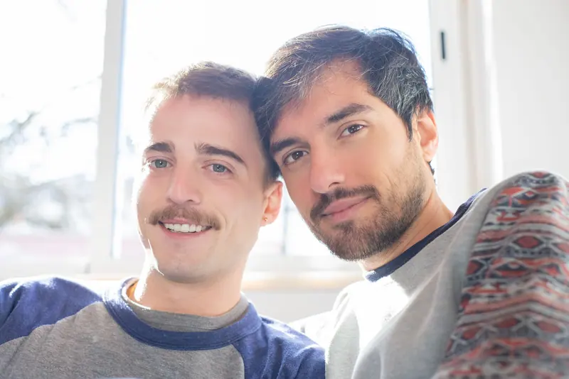 Couple with soft short cuts by a window