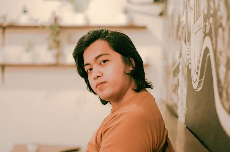 Shoulder-length cut and a tangerine tee