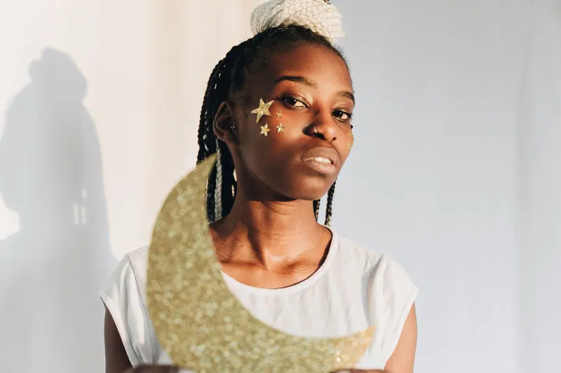 Braids and a glittering gold moon