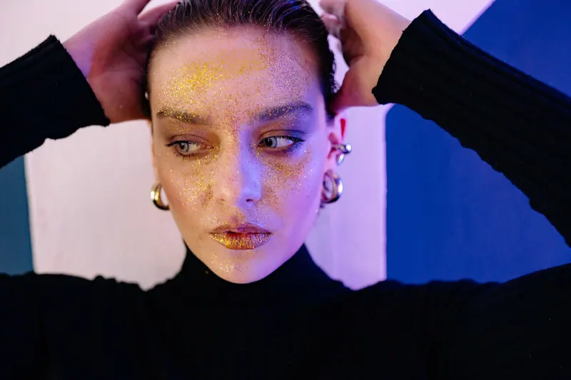 Gold glitter and slicked-back hair
