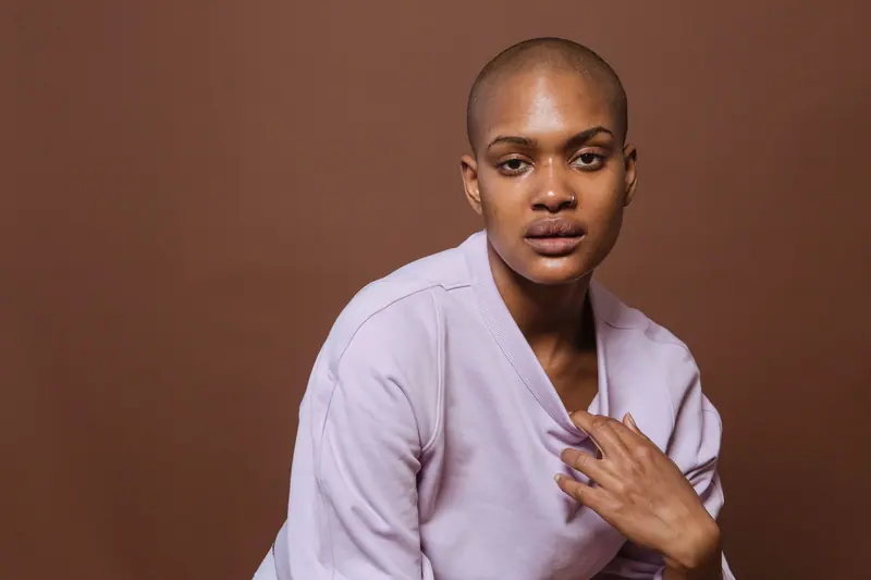 Close-cropped natural hair on brown