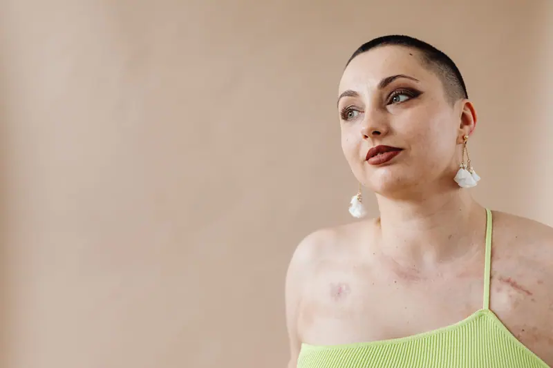 Portrait of a young woman with buzz cut and tattoos, embracing self-love and confidence