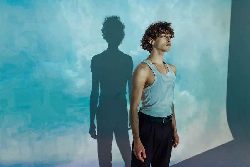 Curly crop and a tank top against blue
