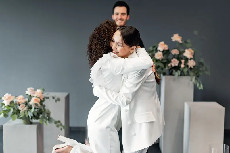 Brides embracing after the ceremony