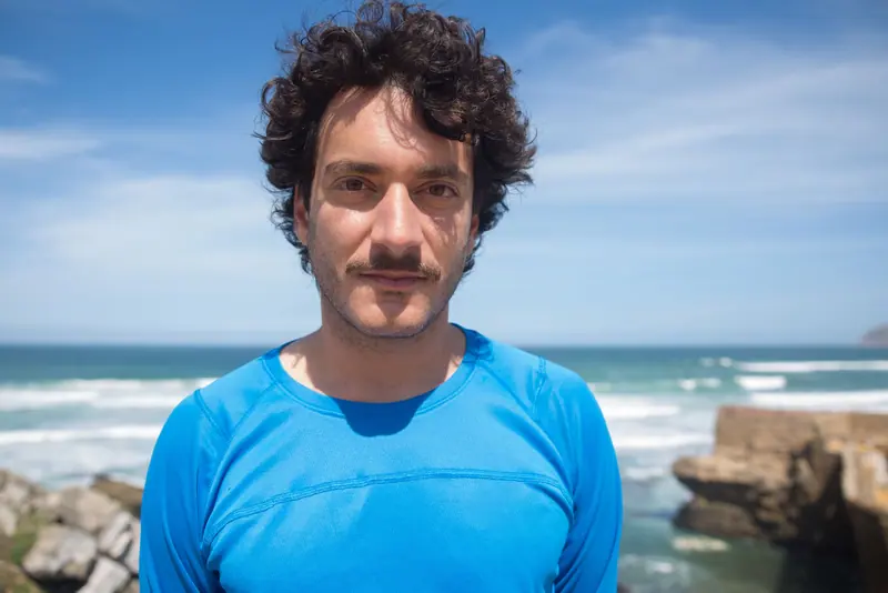 Dark curls against an open sea sky
