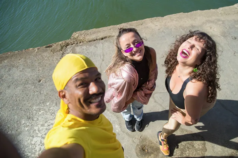 Happy friends laughing and enjoying a sunny day outside in Portugal.