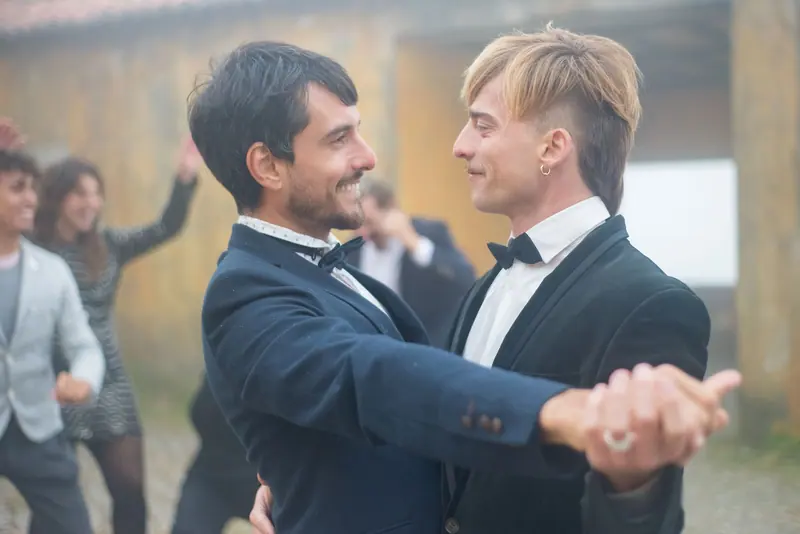 Grooms dancing with their guests