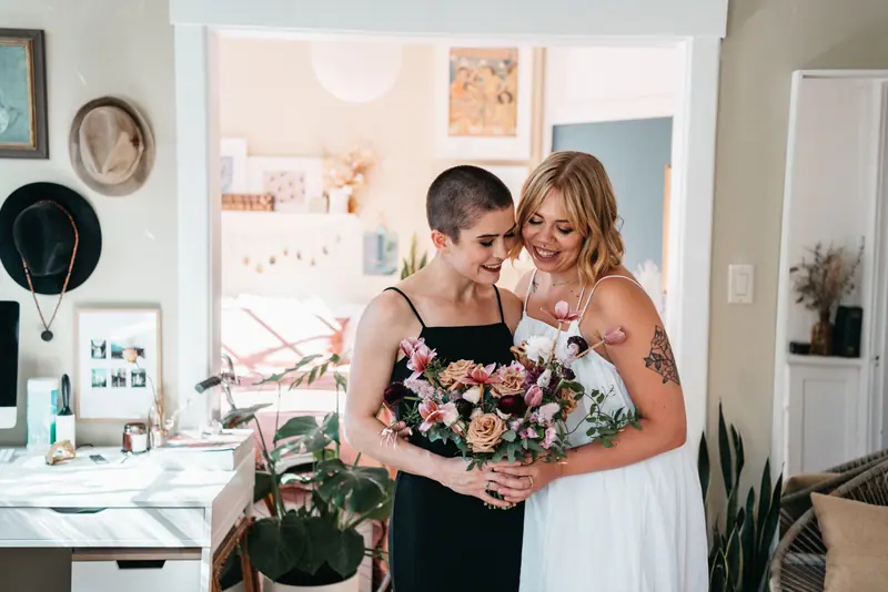 Two brides with a bouquet at home