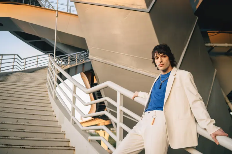 Cream suit and a blue shirt on a stairway
