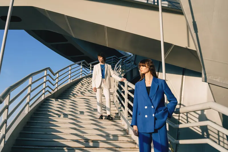 Cobalt and cream suits on a white staircase