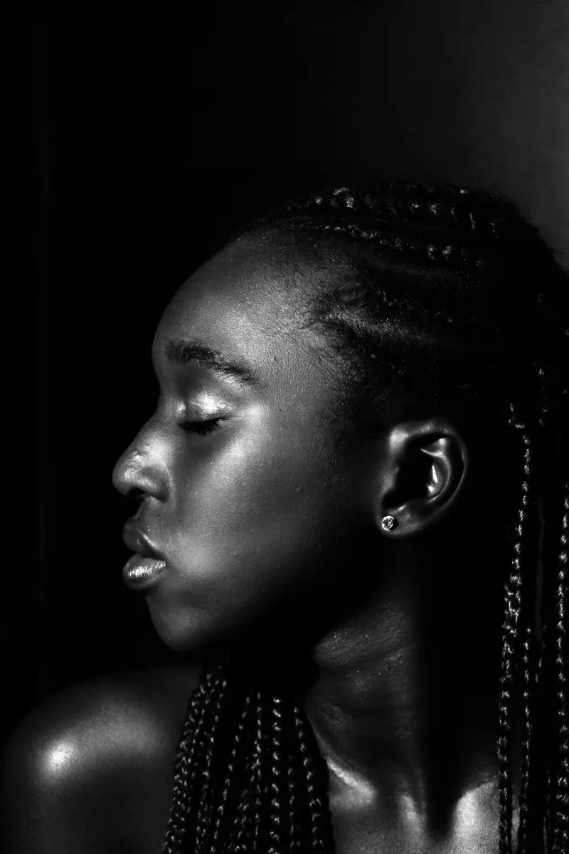 Elegant monochrome portrait of a woman in side profile with braided hair.