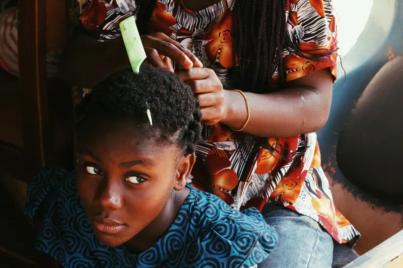 A young girl with braided hair styled, showcasing traditional hairdressing.