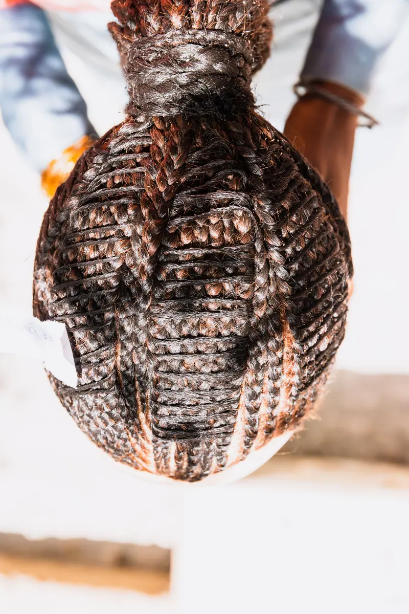 Close-up view of a beautifully intricate braided hair bun from above, highlighting the craftsmanship.