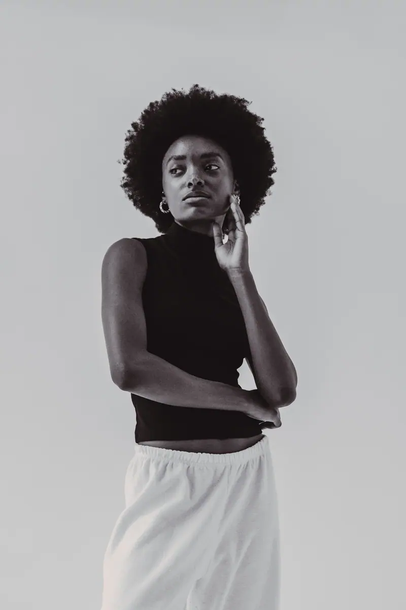Elegant black and white portrait of a young woman in casual contemporary style, indoors.