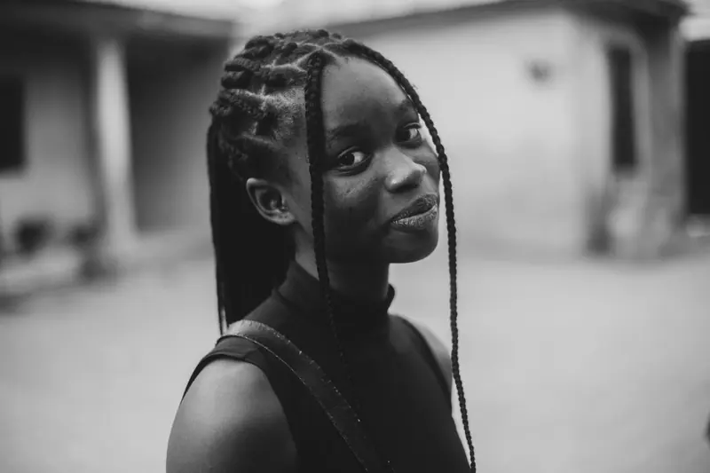 Elegant black and white portrait of a woman with braided hair in Abuja, Nigeria.