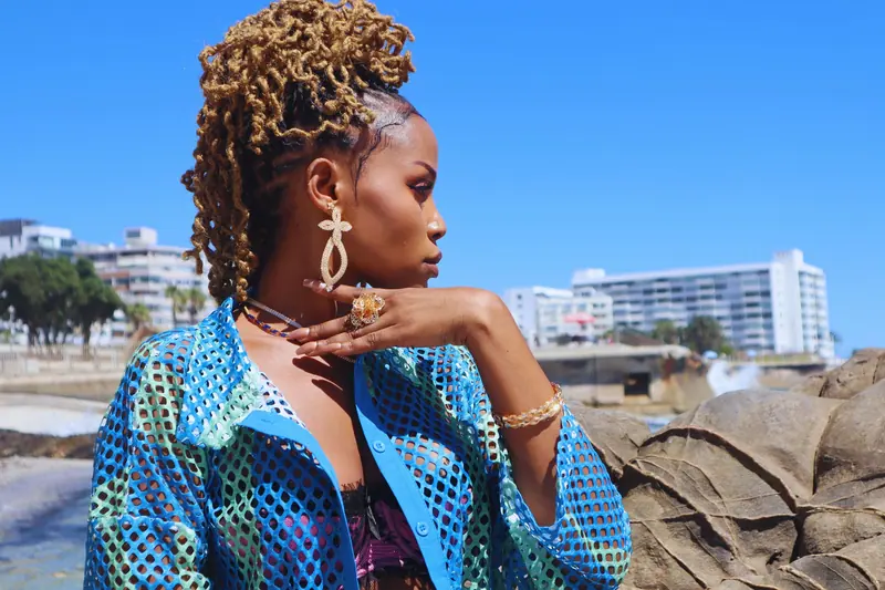 Portrait of a fashionable woman enjoying a sunny day on Cape Town's coast.