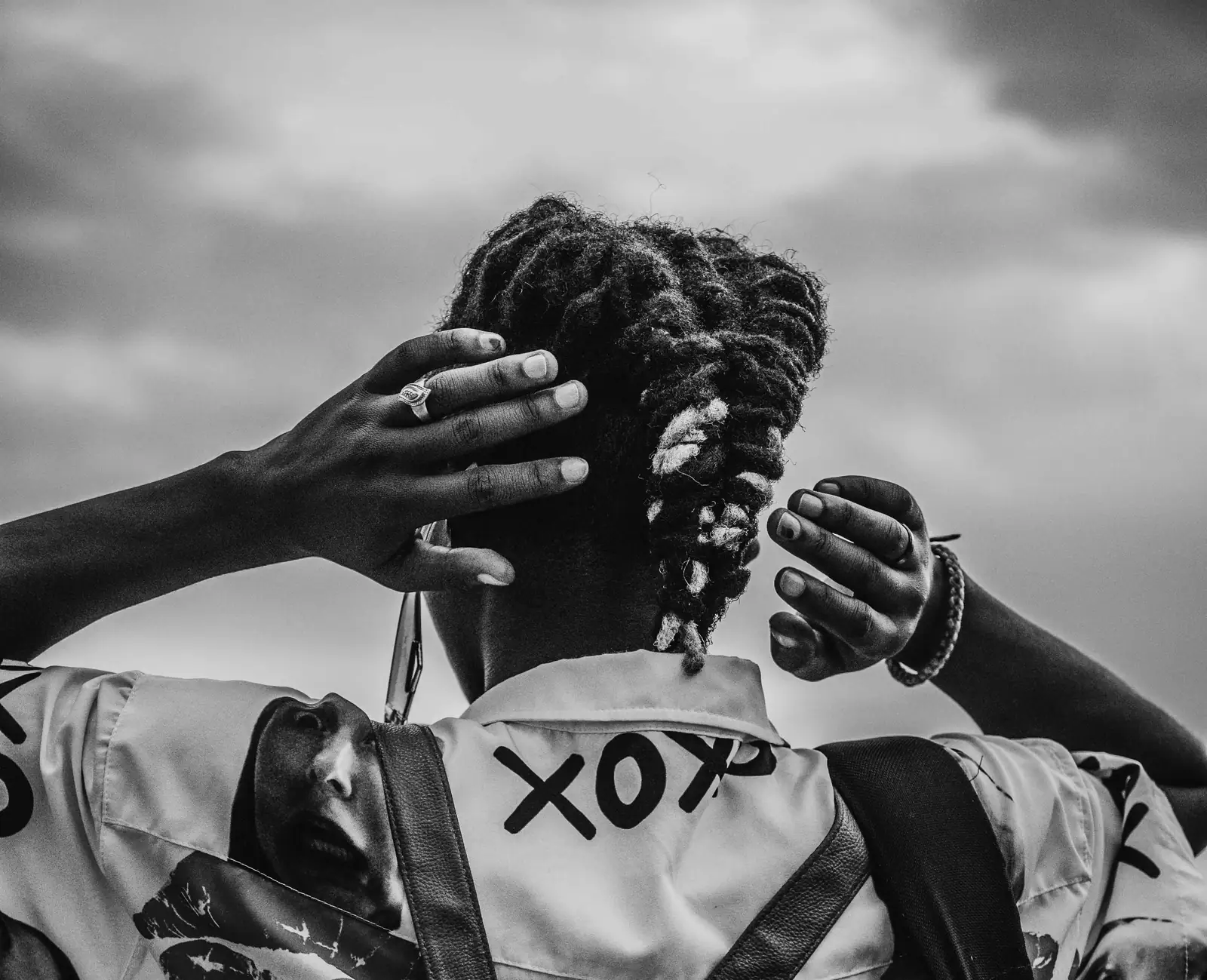 Black-and-white portrait of locs pulled up from behind