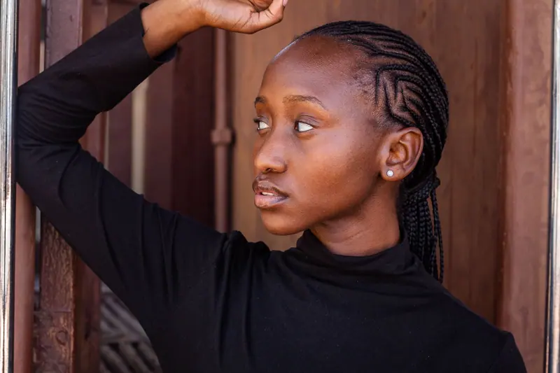 Elegant portrait of a woman with braided hair, captured in a contemplative pose.