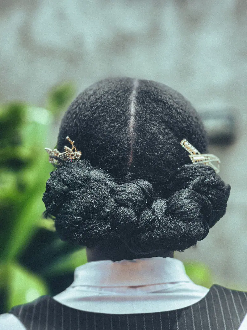 Rear view of a styled updo featuring hair accessories, perfect for formal occasions.