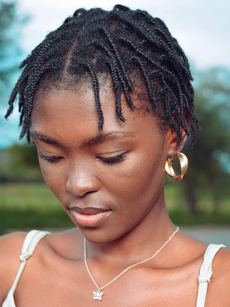 Close-up portrait of an African woman in Orapa, wearing earrings outdoors.