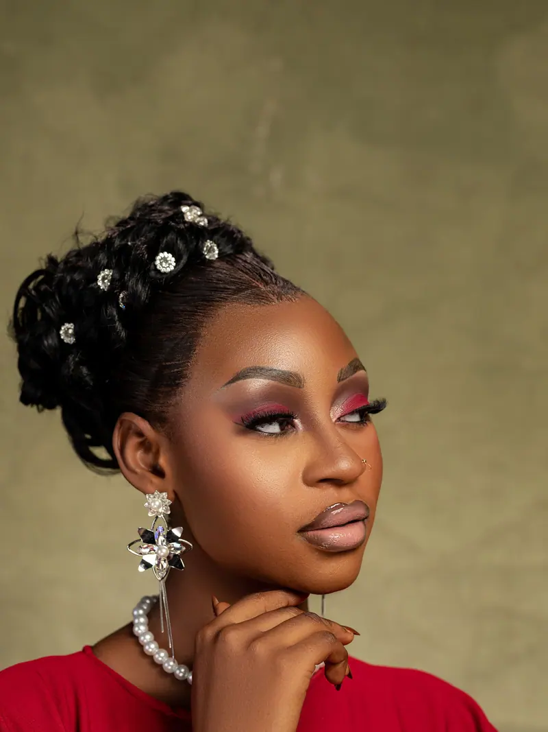 Beautiful portrait of an African woman with an elegant updo hairstyle and jewelry, exuding confidence and grace.