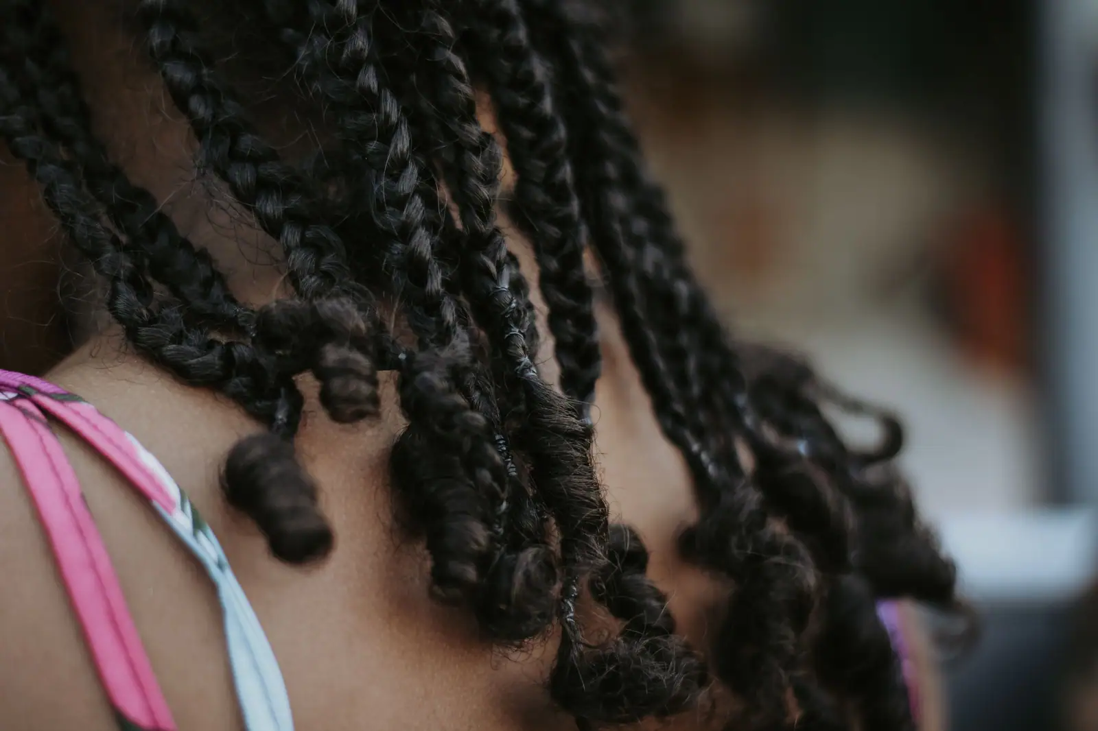 Close-up of long black box braids falling over a shoulder