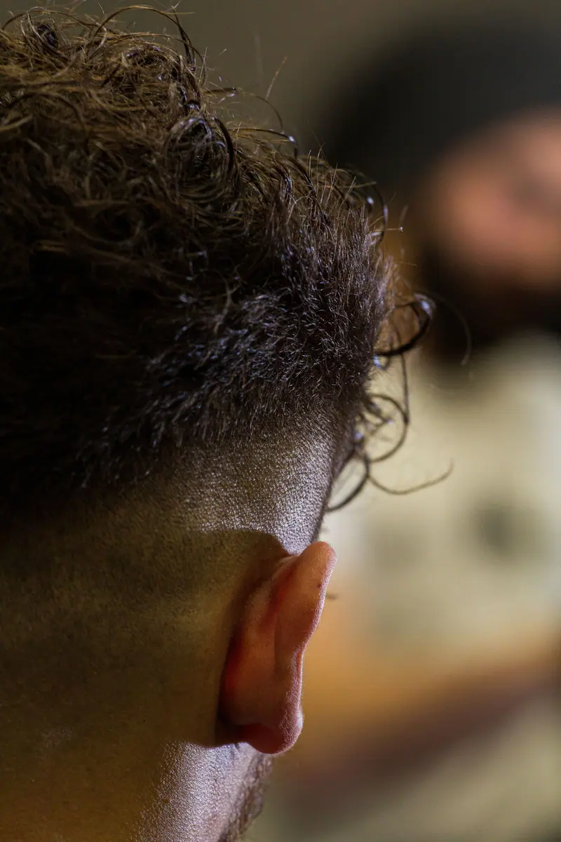 Close-up of a man's modern haircut from behind, highlighting the texture and style.