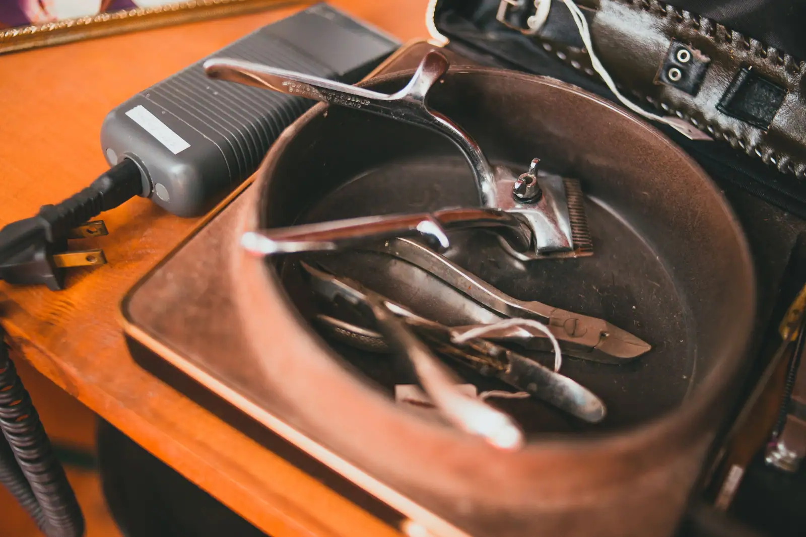 Dottie Kerrigan’s copper bowl of clipper guards and shears on her wooden counter