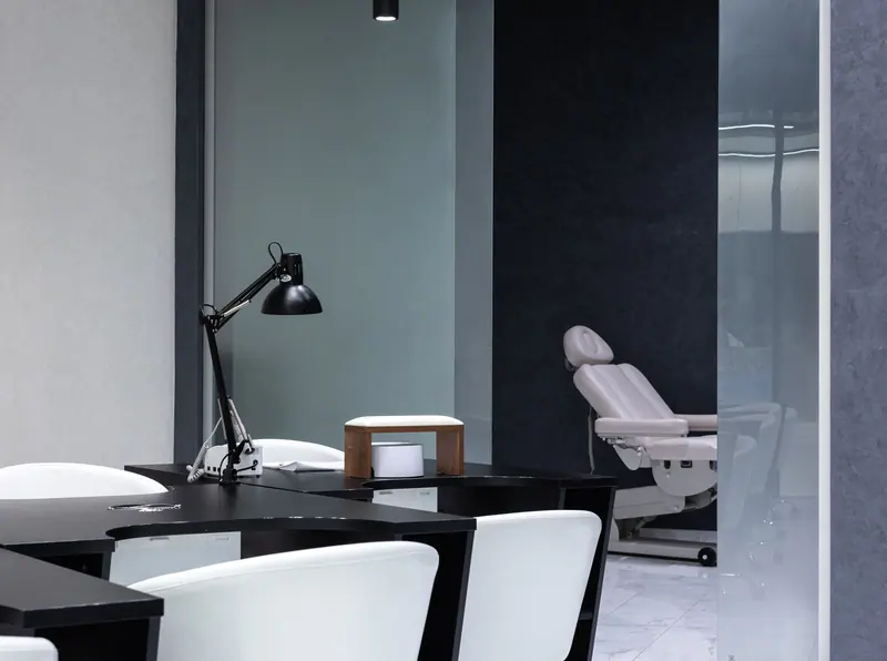 Sleek modern nail salon interior with stylish design and treatment station.
