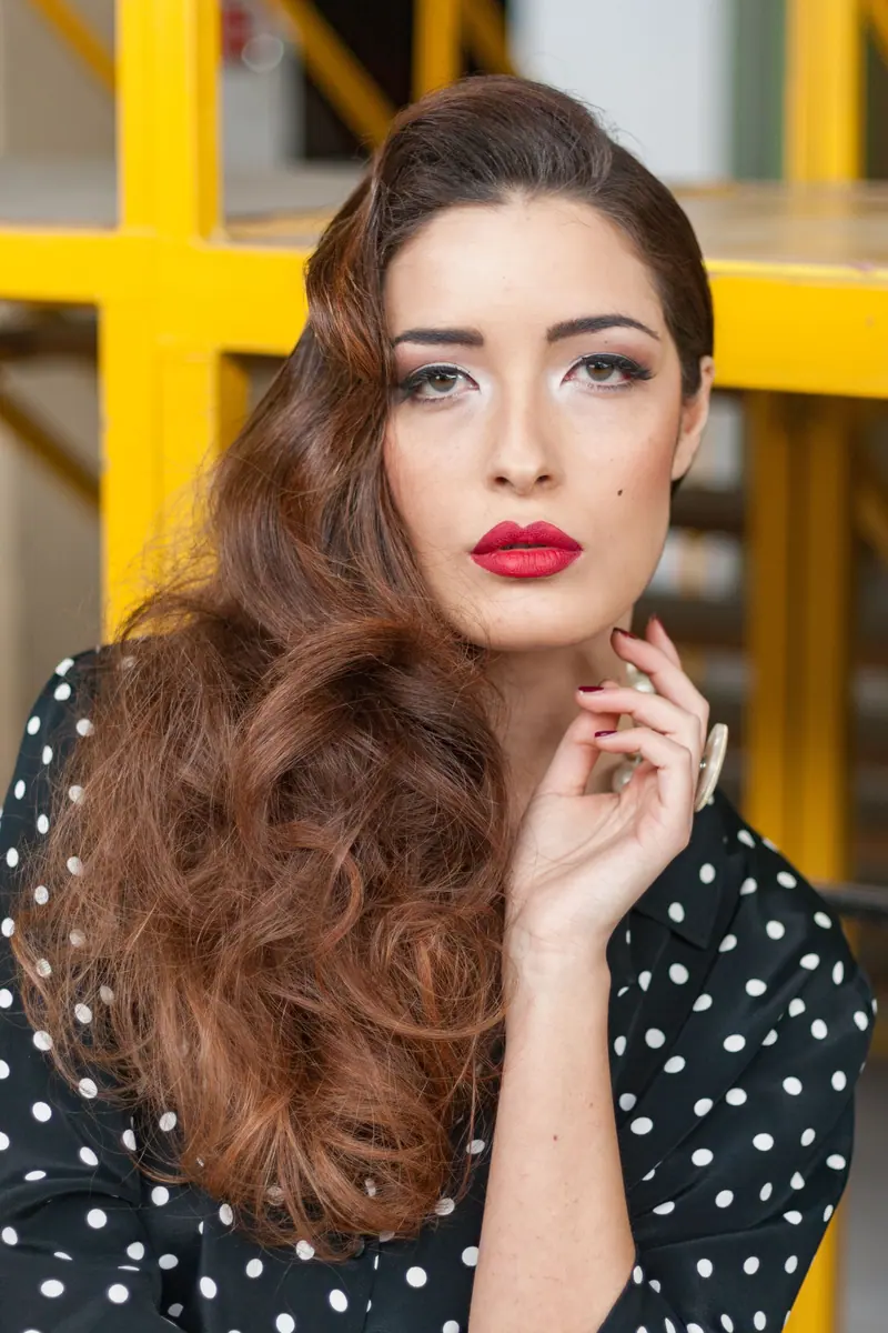 Long brushed-out waves and a polka-dot dress