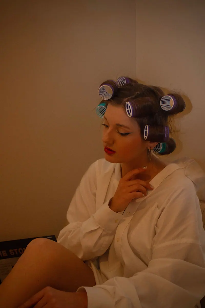 Rollers and a white robe in lamplight