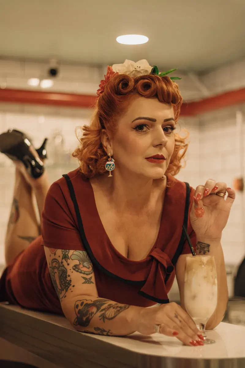 Victory rolls and a flower at a diner counter