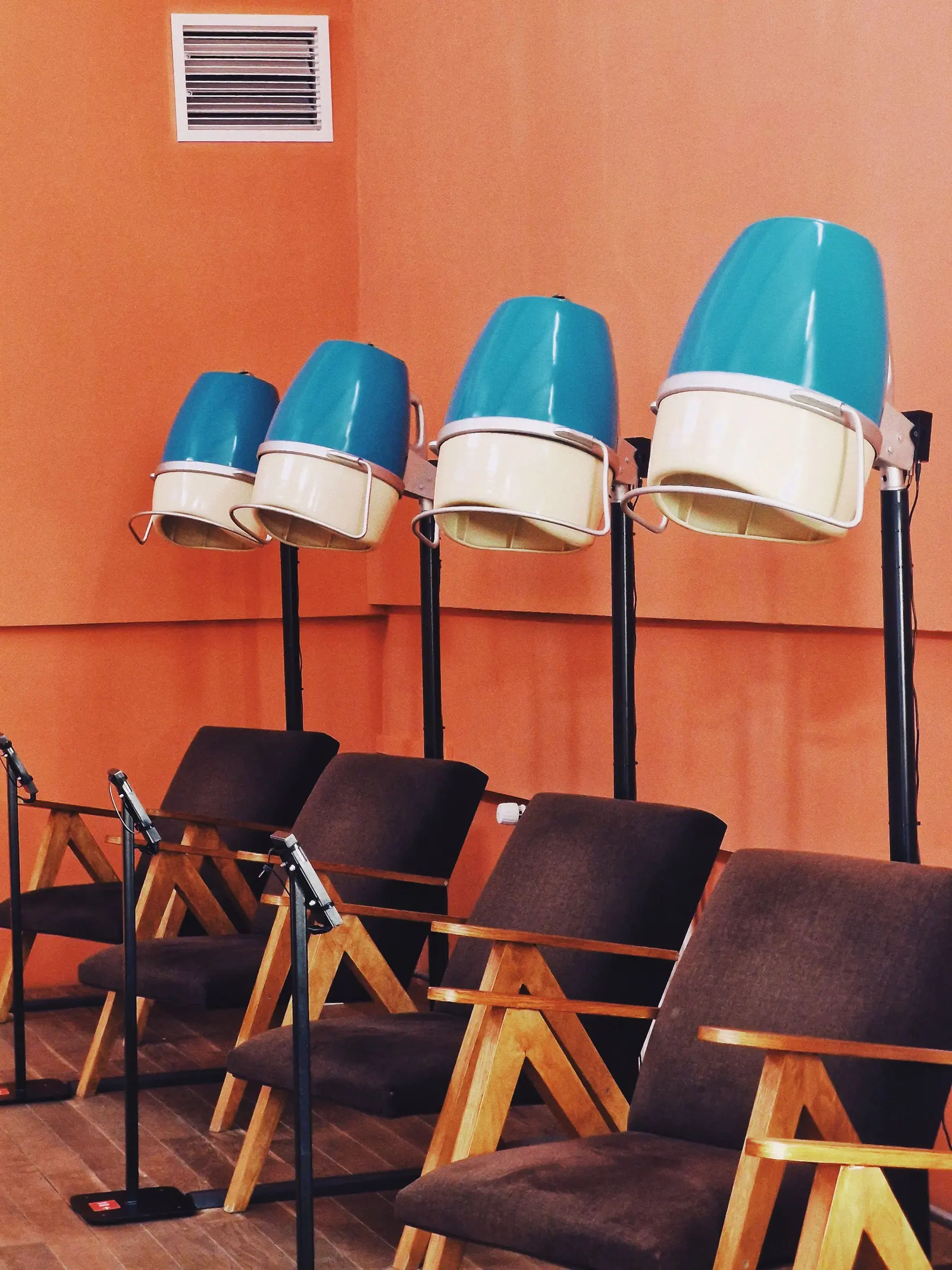 Vintage hair salon with retro dryers and wooden chairs, offering nostalgic charm.
