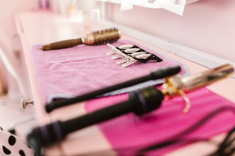 Styling tools on a pink towel