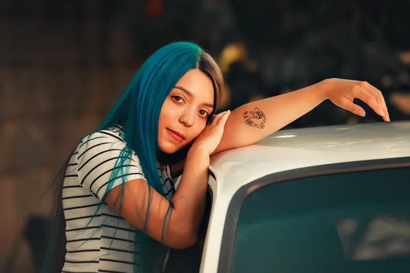 Long teal hair and a striped tee