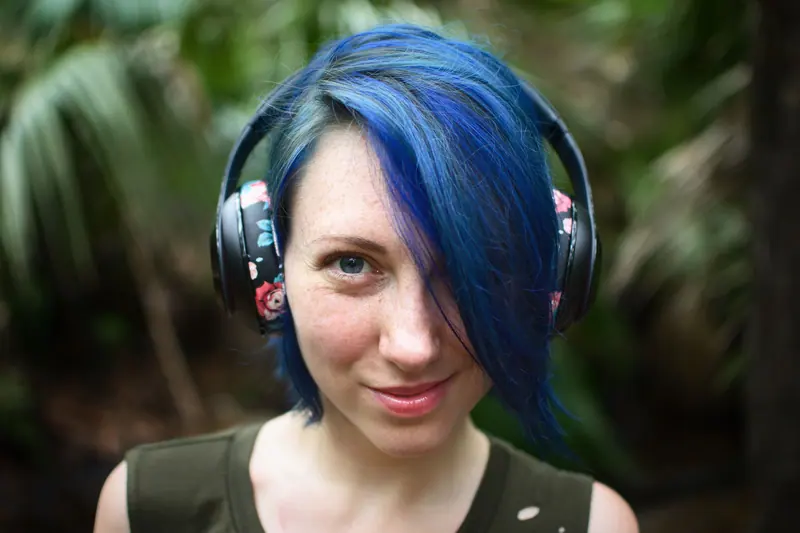 Blue hair and headphones outdoors