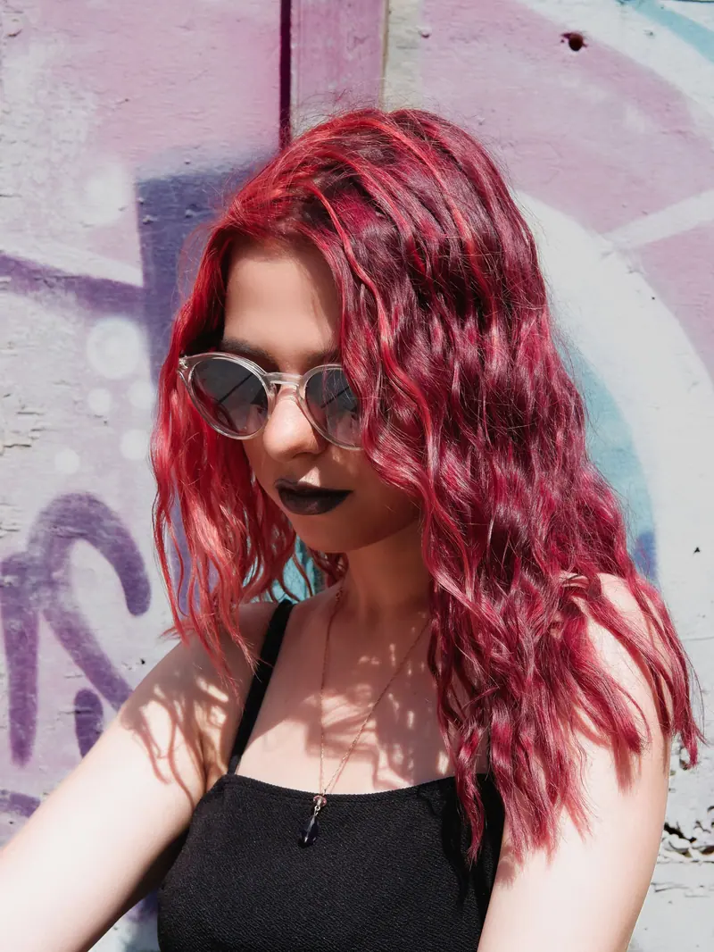 Red hair and dark lipstick against graffiti