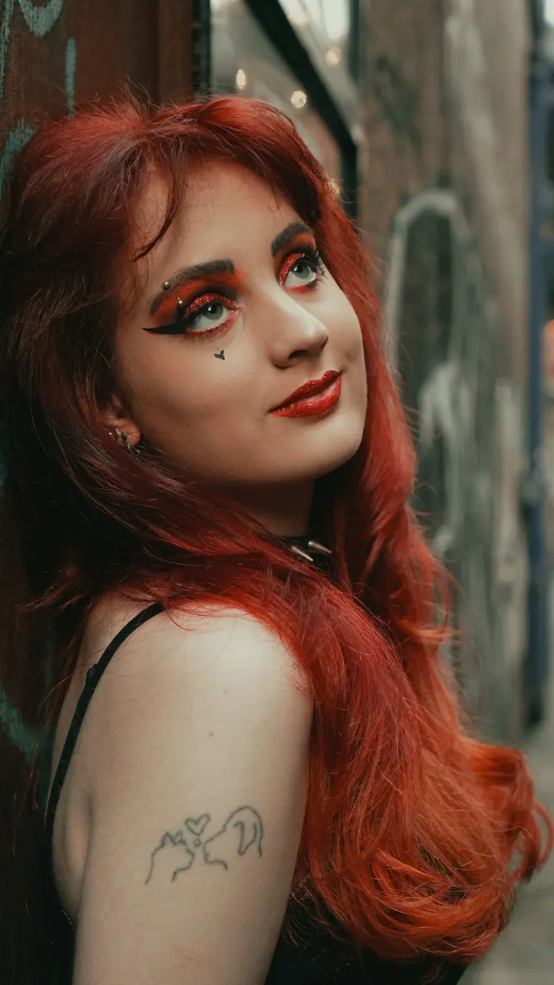 Vivid red hair with artistic eye makeup