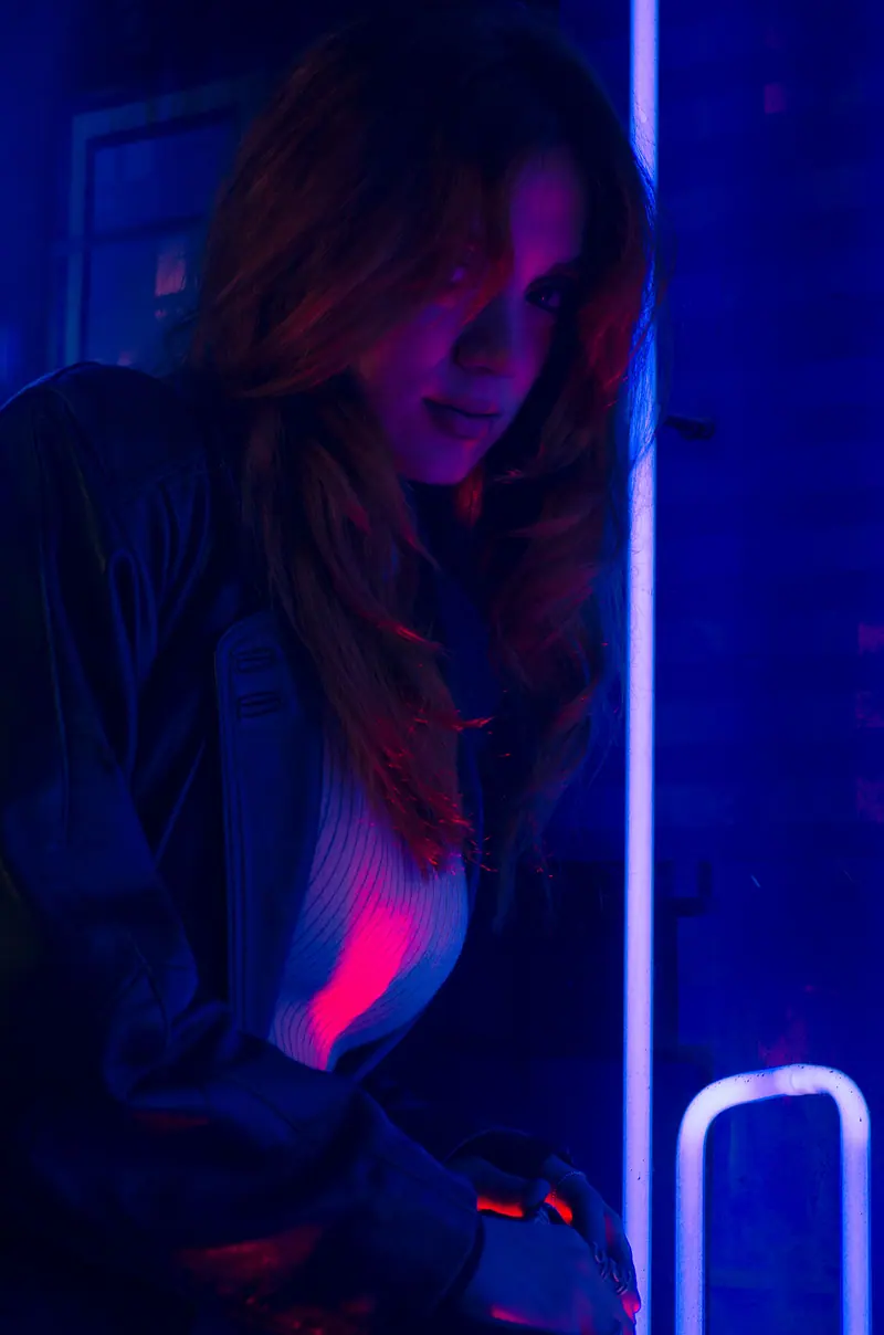 Hair lit by deep blue and pink neon