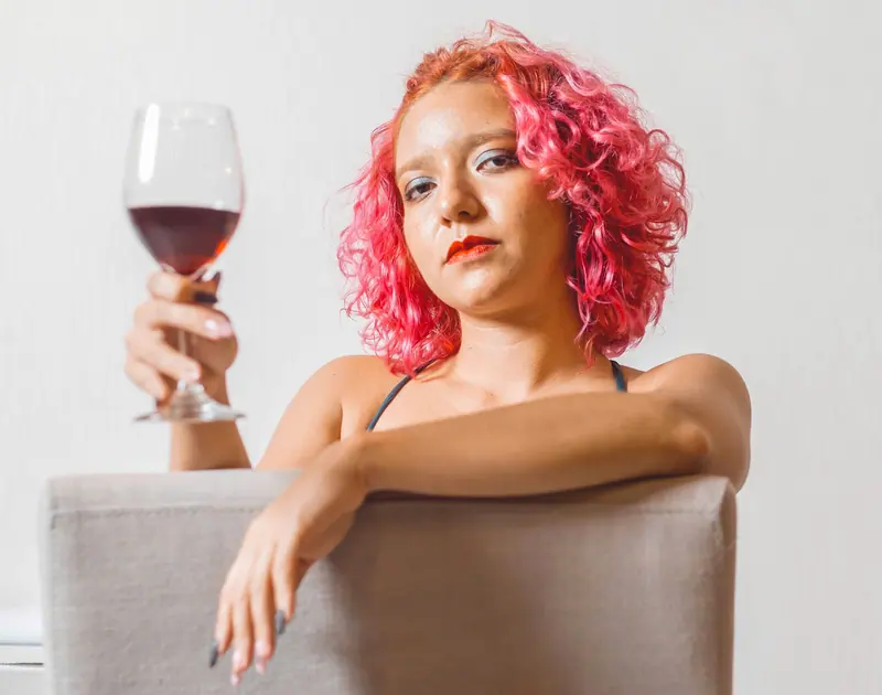 Pink curls and a glass of red