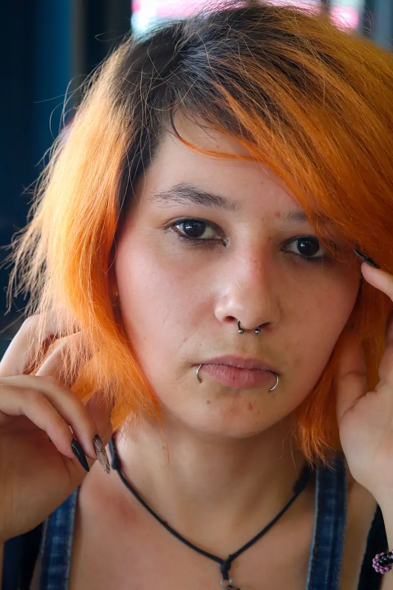 Orange dyed hair and piercings