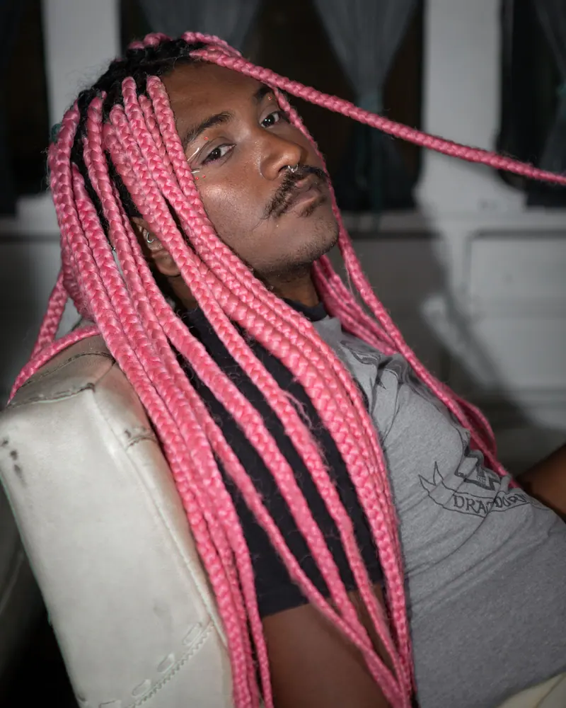 Pink braids and a mustache