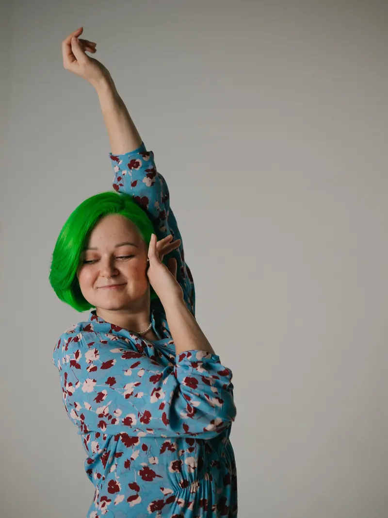 Bright green bob, arms raised
