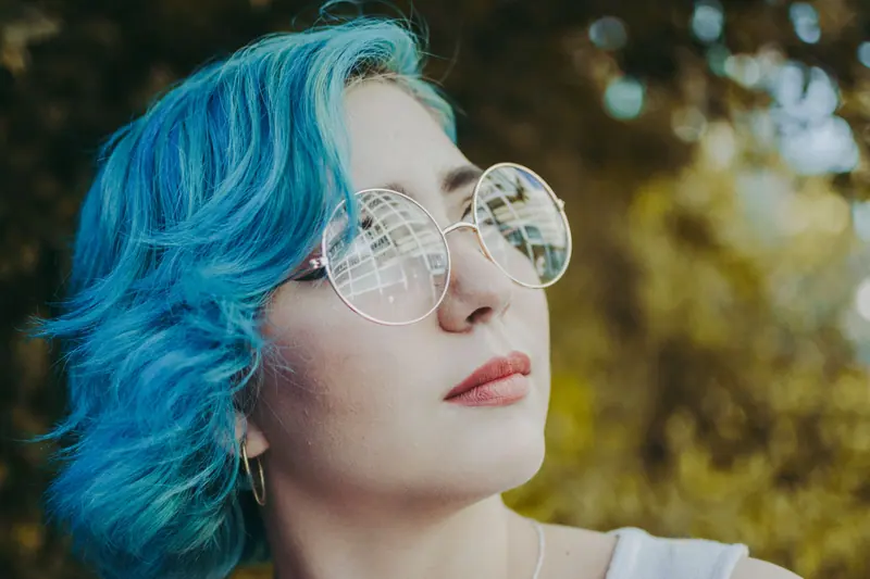 Aqua waves and round glasses in golden light