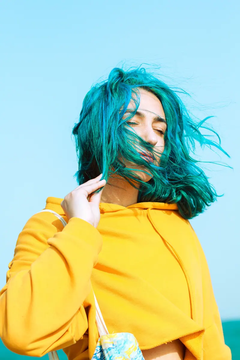 Teal hair caught in the wind