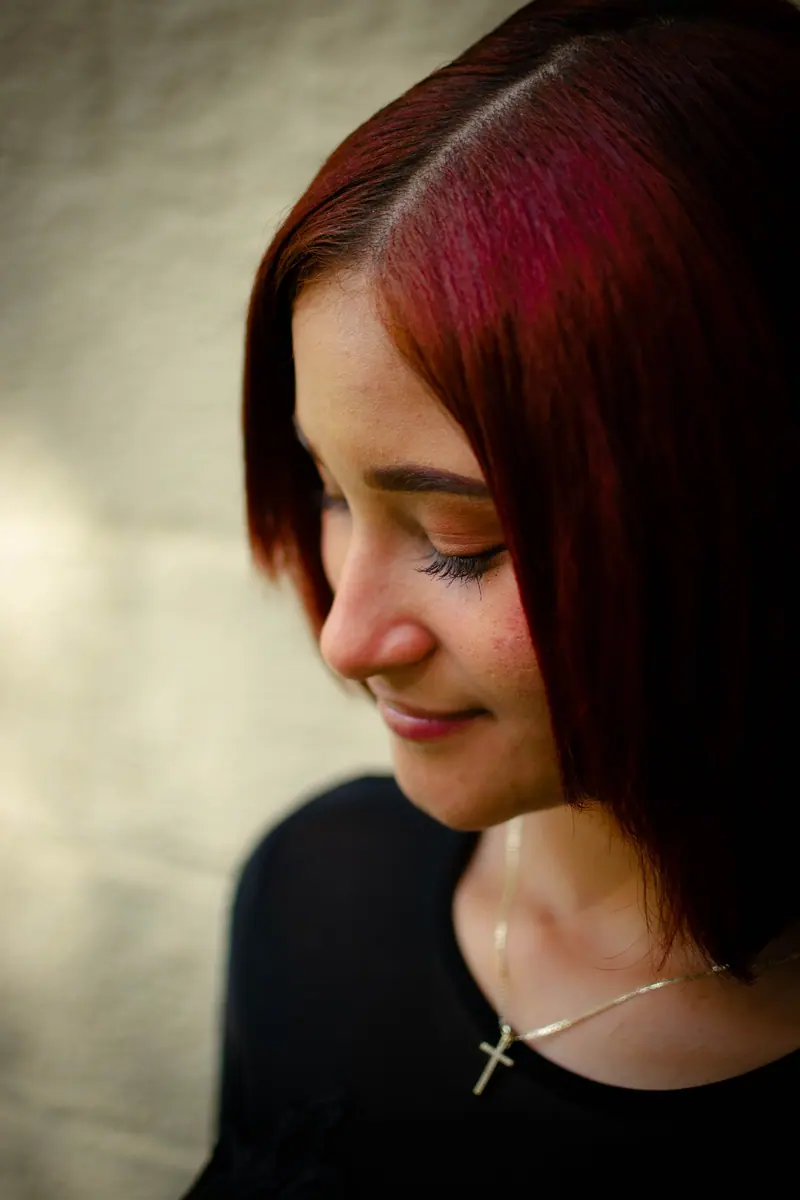 Soft red-copper waves and a gentle smile