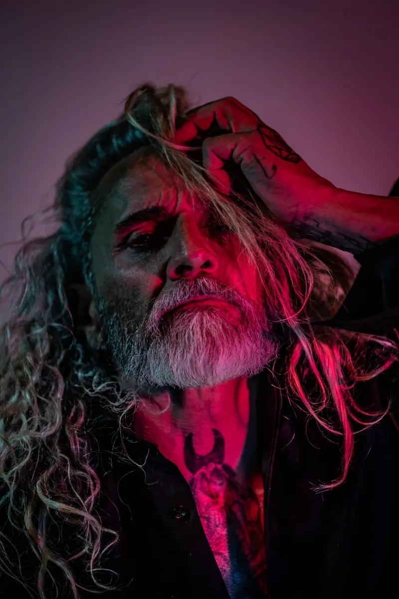 Long silver curls in deep pink light