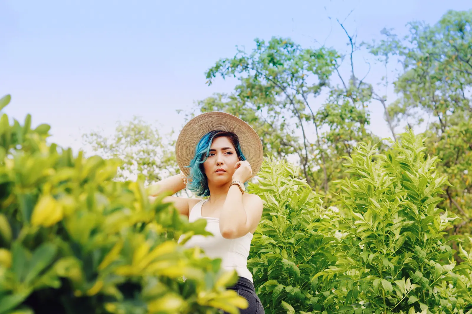 Teal hair under a summer hat
