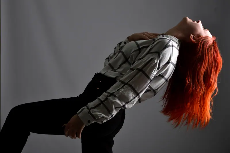 Bright red waves swinging as the client leans back
